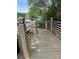Exterior boardwalk featuring wood planks and a metal handrail to a community parking area at 14608 Waterside Dr, Charlotte, NC 28278