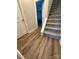 View of hallway with wood floors and carpeted stairs at 14608 Waterside Dr, Charlotte, NC 28278