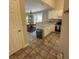 Open kitchen view with white cabinets, breakfast bar, and adjacent dining area at 14608 Waterside Dr, Charlotte, NC 28278