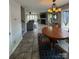 Open-concept living and dining area with tile floors and a cozy fireplace at 14608 Waterside Dr, Charlotte, NC 28278