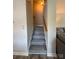 Carpeted stairway with wood railing, leading to upper level at 14608 Waterside Dr, Charlotte, NC 28278