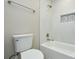 This bathroom features white tile, a showerhead, and a tub with an inset tiled soap and shampoo nook at 14821 Cumberland Dr, Charlotte, NC 28227