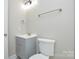 Cozy bathroom with modern fixtures, tiled shower, and vanity with gray cabinets at 14821 Cumberland Dr, Charlotte, NC 28227