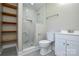 This bathroom features modern fixtures, a tiled shower, shelving, and sleek design at 14821 Cumberland Dr, Charlotte, NC 28227