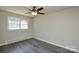 This bedroom offers hardwood floors and a ceiling fan for added comfort at 14821 Cumberland Dr, Charlotte, NC 28227