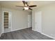 This bedroom offers hardwood floors, a ceiling fan, closet space, and access to the bathroom at 14821 Cumberland Dr, Charlotte, NC 28227