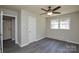 This bedroom offers hardwood floors, a ceiling fan, closet space, and good natural light at 14821 Cumberland Dr, Charlotte, NC 28227