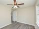 Bright bedroom with laminate flooring, a ceiling fan, and closet at 14821 Cumberland Dr, Charlotte, NC 28227