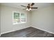 Neutral bedroom with laminate flooring, ceiling fan and a bright window at 14821 Cumberland Dr, Charlotte, NC 28227