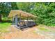 Exterior shot of a backyard shed with seating at 14821 Cumberland Dr, Charlotte, NC 28227