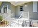 Inviting entryway features a gray painted brick exterior and white-painted stairs and railing at 14821 Cumberland Dr, Charlotte, NC 28227