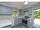 Updated kitchen with gray cabinets, stainless steel appliances, and white quartz counters at 14821 Cumberland Dr, Charlotte, NC 28227
