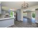 Open kitchen with gray cabinetry and an elegant light fixture, perfect for entertaining at 14821 Cumberland Dr, Charlotte, NC 28227