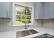 Close-up of the kitchen sink with stainless steel faucet and a window with a view at 14821 Cumberland Dr, Charlotte, NC 28227