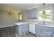 Open kitchen featuring gray cabinets, stainless steel appliances, and an eat-in island at 14821 Cumberland Dr, Charlotte, NC 28227