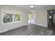 Inviting living room with a large window, open door, and modern floor at 14821 Cumberland Dr, Charlotte, NC 28227