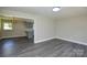 Open-concept living space featuring modern floor, adjacent to the updated kitchen at 14821 Cumberland Dr, Charlotte, NC 28227