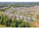 Aerial view of neighborhood, featuring lush greenery and well-maintained homes on a sunny day at 15103 Keyes Meadow Way, Huntersville, NC 28078