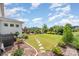 Serene backyard featuring a lush lawn, stone pathway, and beautifully landscaped garden beds at 15103 Keyes Meadow Way, Huntersville, NC 28078
