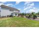 Expansive backyard with a patio, grassy area, and beautifully landscaped sections, perfect for outdoor living at 15103 Keyes Meadow Way, Huntersville, NC 28078