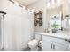 Modern bathroom featuring a shower with a white curtain, white toilet, and a decorative wooden shelf at 15103 Keyes Meadow Way, Huntersville, NC 28078