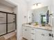 Elegant bathroom with dual sinks, granite countertops, and a large shower with a sleek black frame at 15103 Keyes Meadow Way, Huntersville, NC 28078