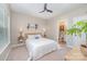 Cozy bedroom with a ceiling fan, neutral walls, and a comfortable queen-size bed at 15103 Keyes Meadow Way, Huntersville, NC 28078