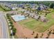 Neighborhood features playground, pool, and clubhouse surrounded by lush green spaces and mature trees at 15103 Keyes Meadow Way, Huntersville, NC 28078