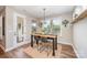 Charming dining area with high-top table, modern light fixture, and large windows providing ample natural light at 15103 Keyes Meadow Way, Huntersville, NC 28078