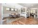 Spacious dining room with a wooden table, gray chairs, a bar, and stylish decor at 15103 Keyes Meadow Way, Huntersville, NC 28078