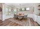 Elegant dining room featuring a modern table, stylish chairs, and natural light from large windows at 15103 Keyes Meadow Way, Huntersville, NC 28078