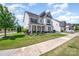 Beautiful home featuring well-maintained landscaping, a welcoming front porch, and a sidewalk at 15103 Keyes Meadow Way, Huntersville, NC 28078