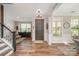 Bright foyer with hardwood floors, wainscoting, and staircase showcasing the home's interior at 15103 Keyes Meadow Way, Huntersville, NC 28078