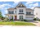 Charming two-story home boasts a manicured lawn, inviting porch, and a two-car garage at 15103 Keyes Meadow Way, Huntersville, NC 28078