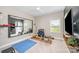 Home gym featuring a full mirror wall, rowing machine, blue workout mat, and a ceiling fan at 15103 Keyes Meadow Way, Huntersville, NC 28078