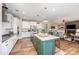 Modern kitchen with island, stainless appliances, white cabinets, and an open layout into the living room at 15103 Keyes Meadow Way, Huntersville, NC 28078