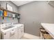 Functional laundry room equipped with washer, dryer, shelving, and ample counter space at 15103 Keyes Meadow Way, Huntersville, NC 28078