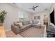 Relaxing living room featuring a plush grey sectional couch, a patterned rug, and plenty of natural light at 15103 Keyes Meadow Way, Huntersville, NC 28078