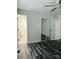 This bedroom has modern flooring, a ceiling fan, and mirrored closet doors at 1535 Jordan St, Lancaster, SC 29720