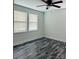 Cozy bedroom with natural light, modern fan, and beautiful hardwood floors at 1535 Jordan St, Lancaster, SC 29720