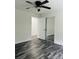 This bedroom features modern flooring, a ceiling fan, and a mirrored closet at 1535 Jordan St, Lancaster, SC 29720