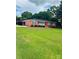 Spacious front lawn leads to this red brick home with covered entry at 1535 Jordan St, Lancaster, SC 29720