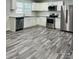 Modern kitchen features stainless steel appliances, white cabinets, and stylish flooring at 1535 Jordan St, Lancaster, SC 29720