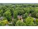 Aerial view of a brick home nestled among mature trees in a desirable neighborhood at 17433 Glassfield Dr, Huntersville, NC 28078