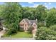 Lovely aerial view of a charming brick two-story home surrounded by mature trees at 17433 Glassfield Dr, Huntersville, NC 28078