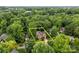 Aerial view of a brick home with property lines marked, nestled among mature trees in a desirable neighborhood at 17433 Glassfield Dr, Huntersville, NC 28078