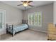 Cozy bedroom with a ceiling fan, neutral walls, and bright light from a window with white shutters at 17433 Glassfield Dr, Huntersville, NC 28078
