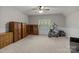 Spacious bonus room with neutral carpet, ceiling fan, and lots of natural light at 17433 Glassfield Dr, Huntersville, NC 28078