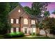 Charming brick two-story home with landscaped front yard taken at twilight at 17433 Glassfield Dr, Huntersville, NC 28078