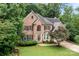 Charming brick two-story home with landscaped front yard surrounded by lush trees at 17433 Glassfield Dr, Huntersville, NC 28078
